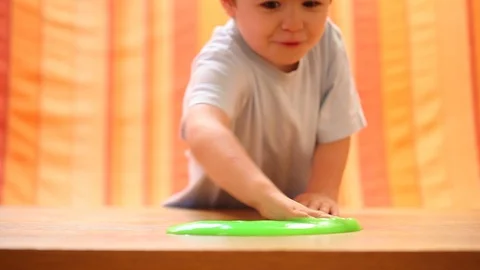Child having fun making slime. Kid Playing Hand Made Toy Slime Stock Footage 94427422