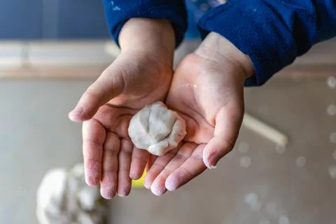 Child having fun modeling salt dough, authentic activity, fine motor skills.. Foto stock