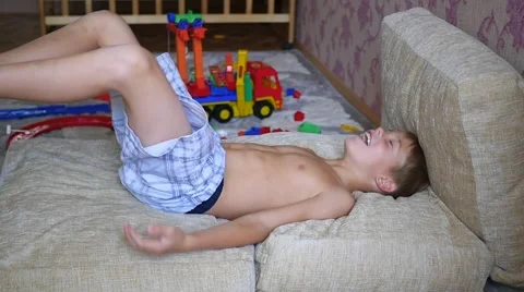The child having fun on the pillows and laughs Vídeo Stock 66620407