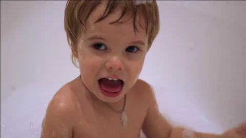 Child having fun playing with foam in the bath 스톡 동영상 69912231