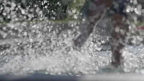 Child having fun at public pool during hot summer day with water droplets s.. Stock Footage 247463868