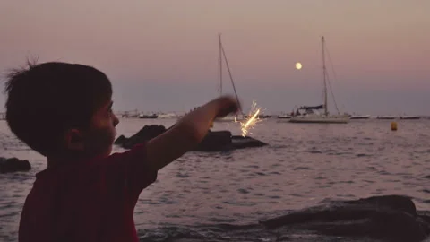 Child having fun with a sparkling flare at sunset Stock Footage 95595522