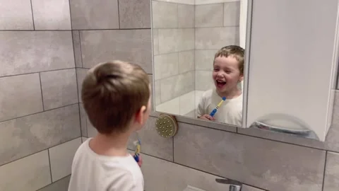 Child having fun with toothbrush in bathroom Stock-Footage 296923318