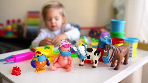 Child having fun with toys on table, creating sweet desserts Stock Footage 269334584