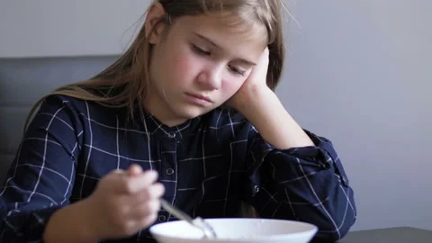 Child having healthy breakfast in kitchen. The girl is not hungry. She refuses Stock-Footage 119022767