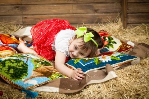 Child, hay, pillows Stock Photos