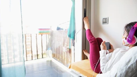Child with headset and mask playing with the phone Stock-Footage 128966619