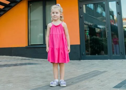 Child with hearing problem and cochlear implant plays in street, deaf kid began Stock Photos