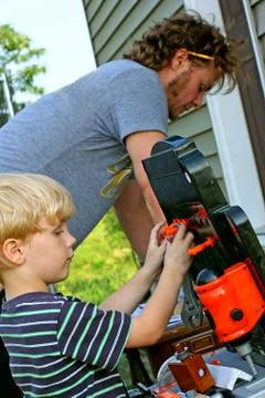 Child helping dad work Stock Photos