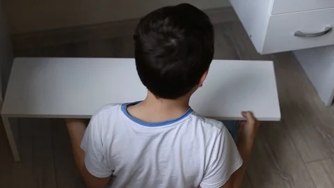 The child helps to collect the white table. Stock Footage 108981055