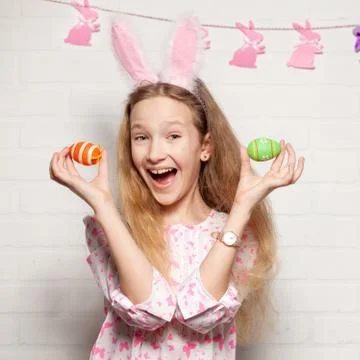 Child is holding a basket with Easter eggs Stock Photos