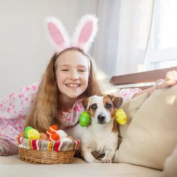Child is holding a basket with Easter eggs Stock Photos
