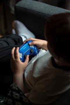 Child Holding Blue Game Controller Indoors Stock Photos