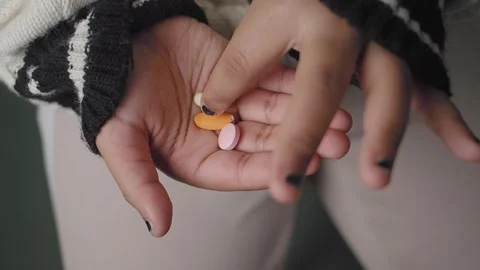 Child Holding different pills in a hand at home Stock Footage 328782951