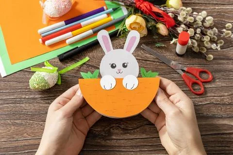 A child is holding an Easter card gift Easter bunny. Handmade. Project of c.. Stock Photos