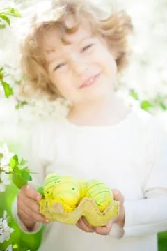 Child holding easter eggs Stock Photos