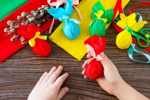 A child holding a gift a decorative Easter eggs. Handmade. Foto stock