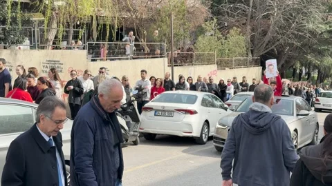 A child holding a large poster of Mayor Ekrem İmamoğlu on top of a car moving  Stock Footage 304830383