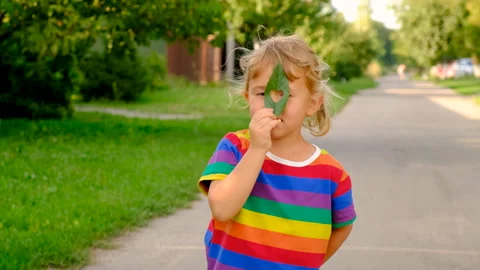 Child holding a leaf of a plant. Selective focus. Stock Footage 288848178