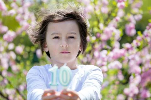Child, holding number candles with 10 on them Stock Photos