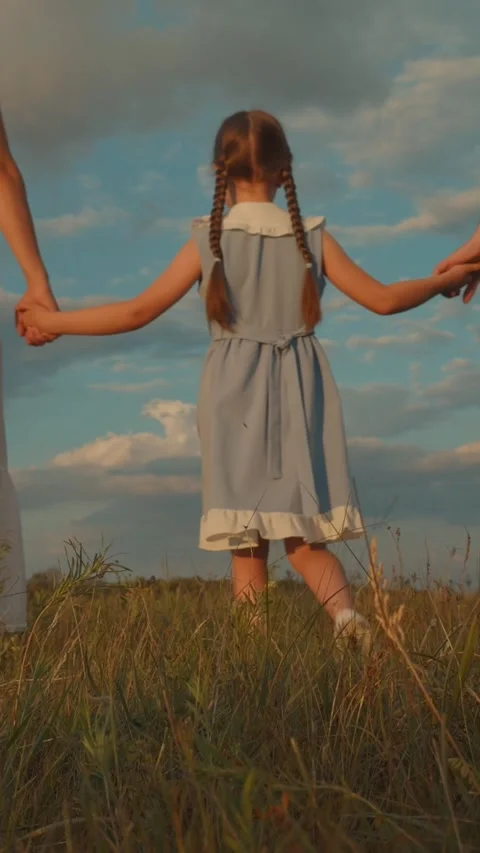 Child holding parent hands while walking sunset, children walk parents dawn Stock Footage 300466452