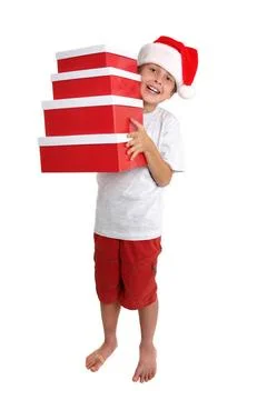 Child holding a stack of gift boxes Boy carrying red and white gift boxes ... Stock Photos