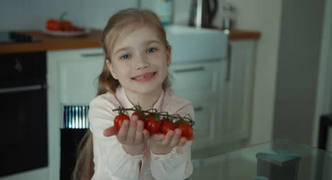 Child holding tomatoes Stock Footage 49646912