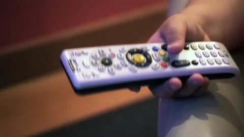 Child Holding TV Remote Control While Watching Television Close Up - 4K Stock Footage 342743421