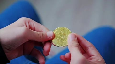 Child Holds Bitcoin Coin Learning About Business and Digital Future Concept Stock Footage 320078478