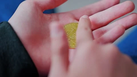 Child Holds Bitcoin Token Showing Growing Curiosity About Money, Digital Finance Stock Footage 344007924
