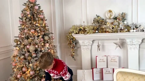 A child holds a box in a festive package. Stock Footage 220714754