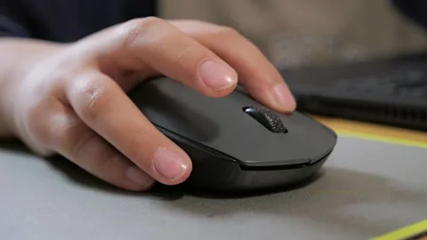 Child holds the computer mouse,child learns and plays on the computer Stock-Footage 266494555