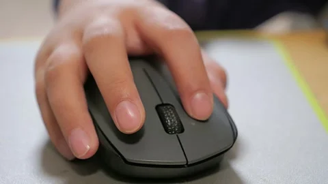 Child holds the computer mouse,child learns and plays on the computer Stock Footage 266494895