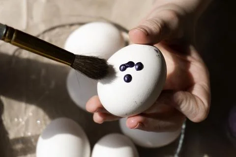 The child holds an Easter egg in his hands. Close-up Stock Photos