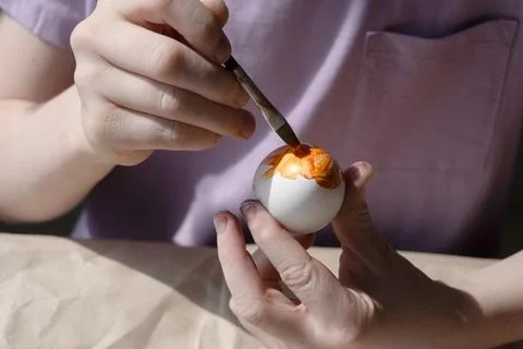The child holds an Easter egg in his hands. Close-up Stock Photos