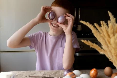 The child holds an Easter egg in his hands. Close-up Stock Photos