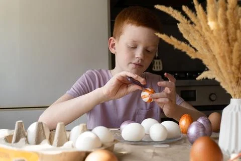 The child holds an Easter egg in his hands. Close-up Stock Photos