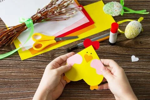 The child is holds Easter postcard Easter chicken. Handmade. Stock Photos