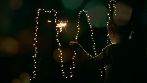 The child holds a sparkler Stock Footage 81322733