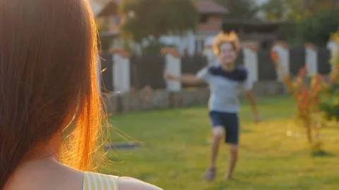 A child is hugging her mother. Daughter rushes into mother's arms and gives her Stock Footage