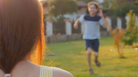 A child is hugging her mother. Daughter rushes into mother's arms and gives her Stock Footage