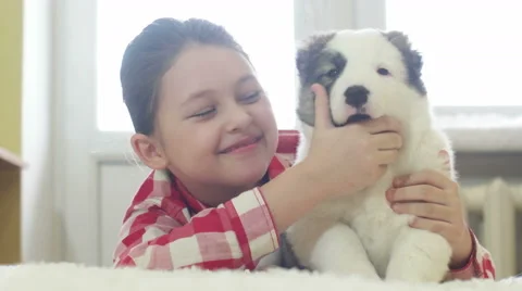 Child hugging a puppy Stock Footage 60448261