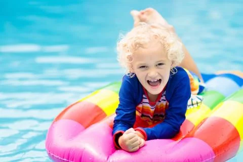 Child on inflatable float in swimming pool. 写真素材