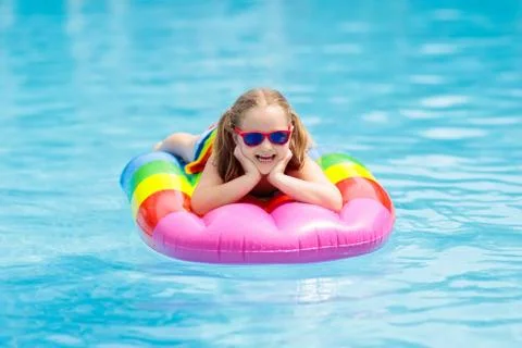Child on inflatable float in swimming pool. 写真素材