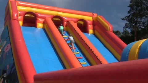 Child on an inflatable trampoline. A Video stock 155703048