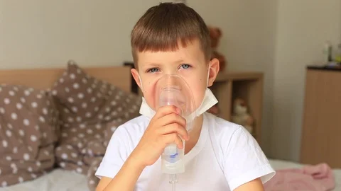A child with an inhaler. Boy got sick Stock Footage 129514194