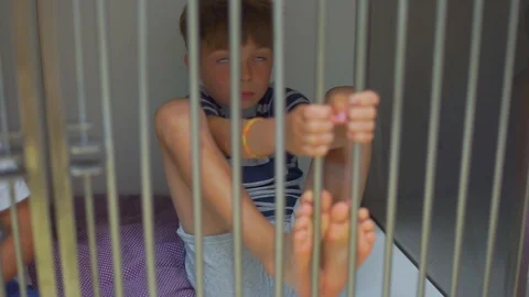 Child in an iron cage Stock Footage 93586141
