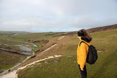 Child in jacket standing on the cliffs Stock Photos