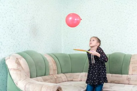 Child juggles balloon Stock Photos