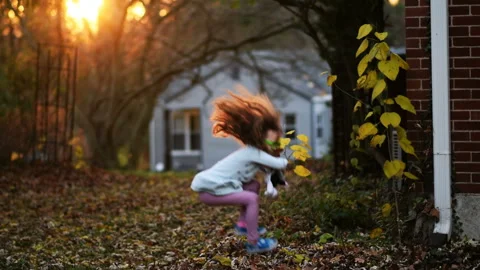 Child jumping in leaves Stock Footage 144910503